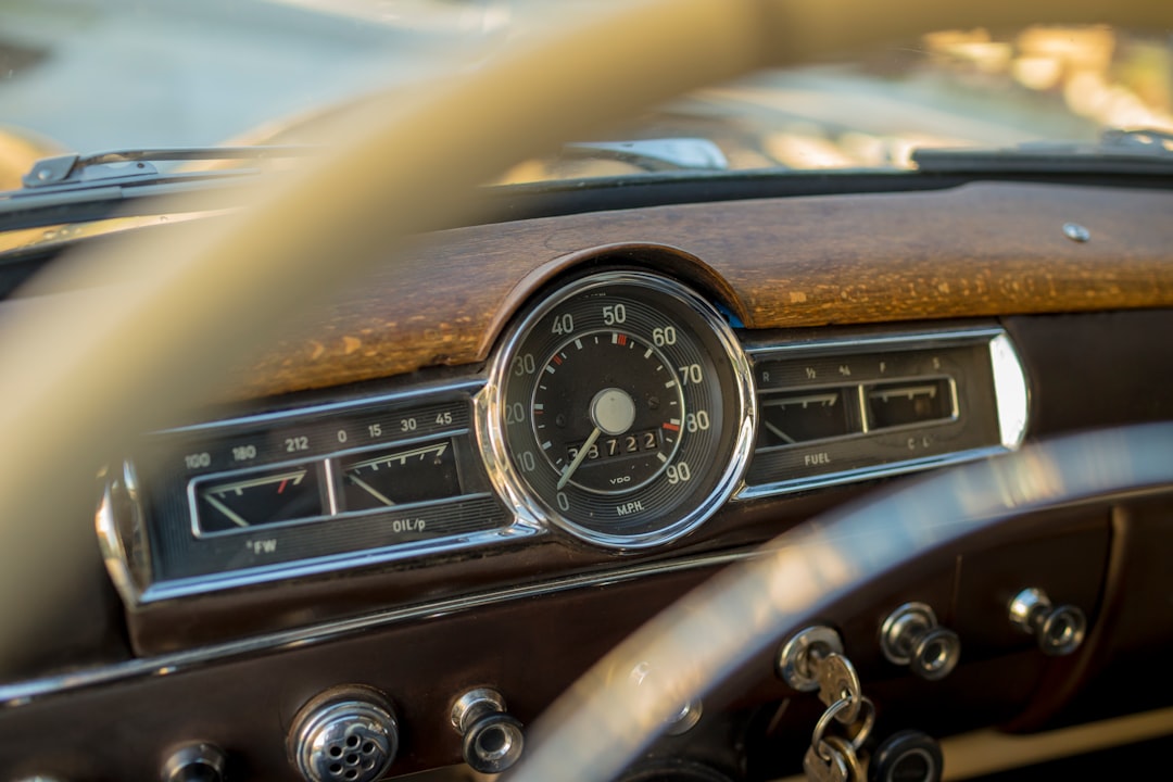 Close-up of a vintage car dashboard, where the central speedometer, reminiscent of personalized finance tracking, rests on a wooden panel with chrome accents. The mileage reads 37,721 miles.