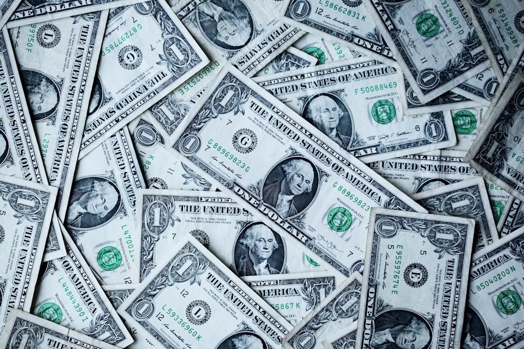 A scattered pile of U.S. one-dollar bills, each showcasing unique serial numbers and seals, offers a tangible glimpse into a financial curriculum waiting to be explored.